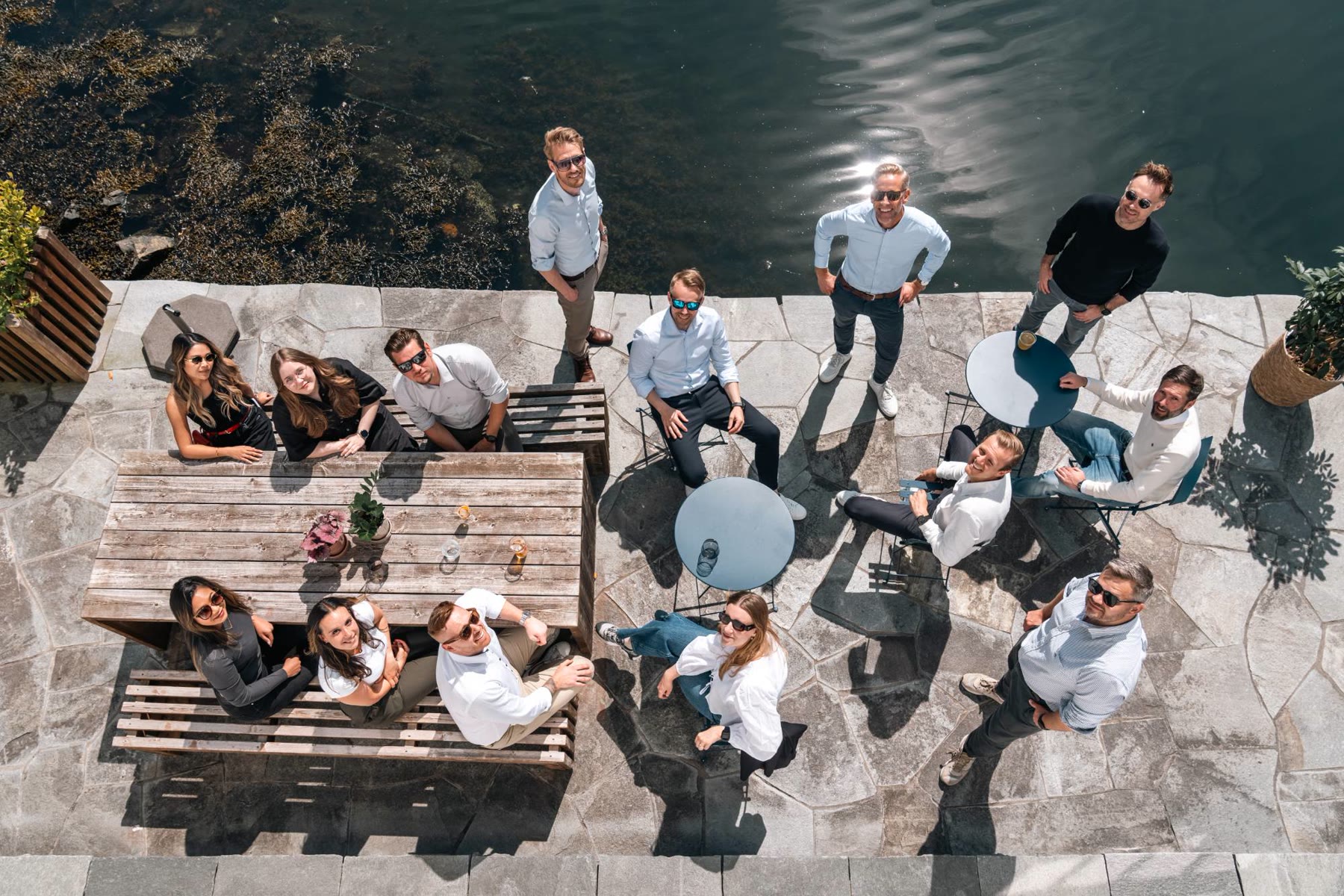 People from Seven Peaks gathered outdoors on a quay, photographed from above.
